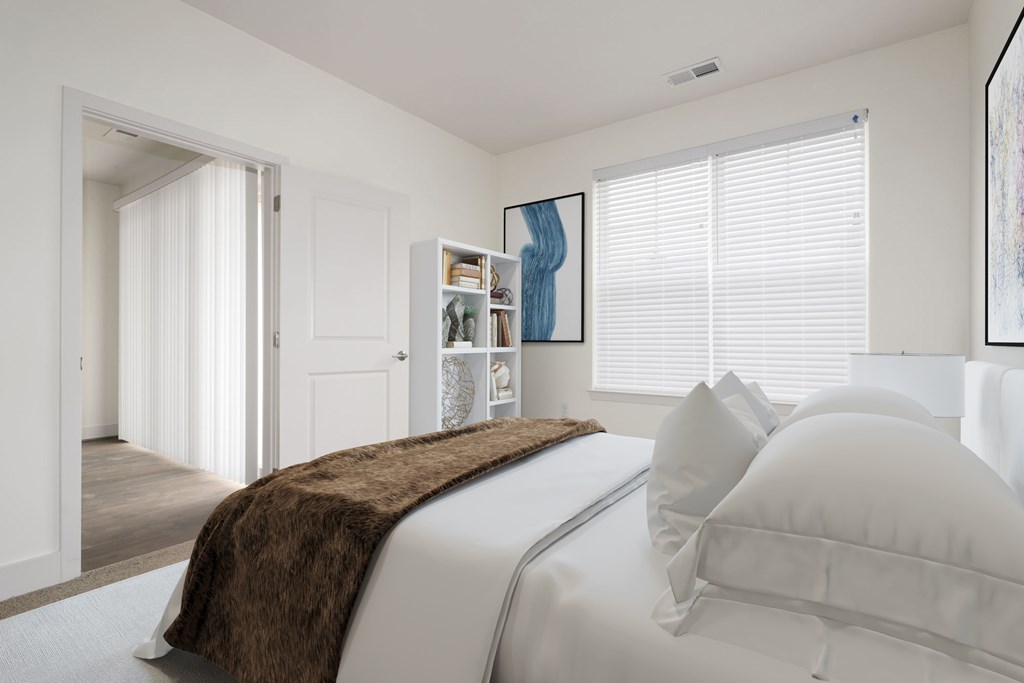 a white bedroom with a large bed and a closet
